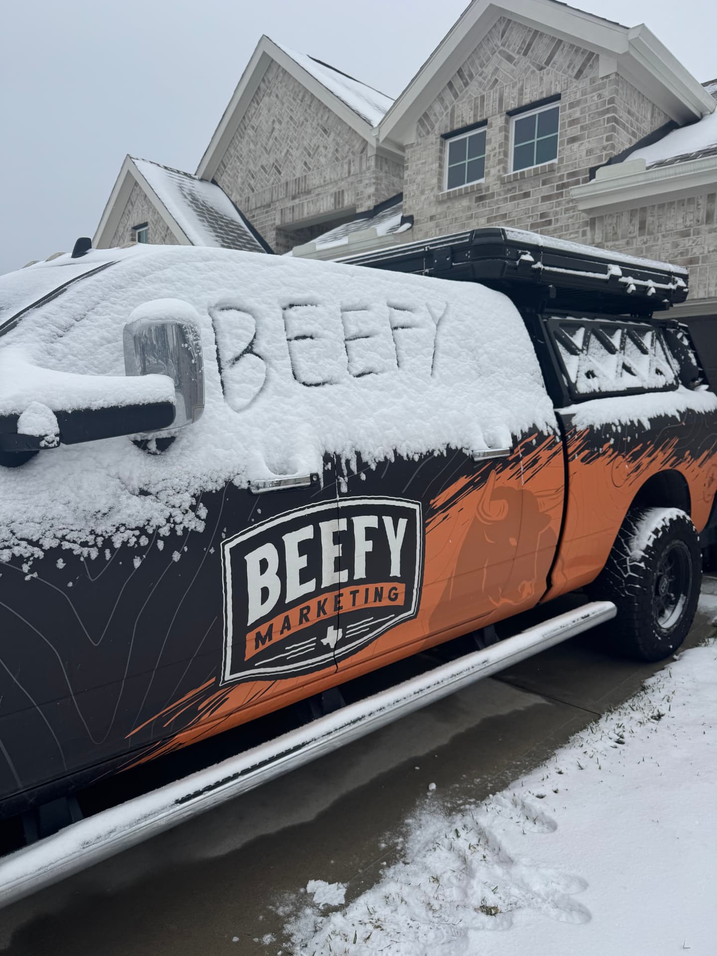 Beefy Marketing truck covered in snow after a winter storm